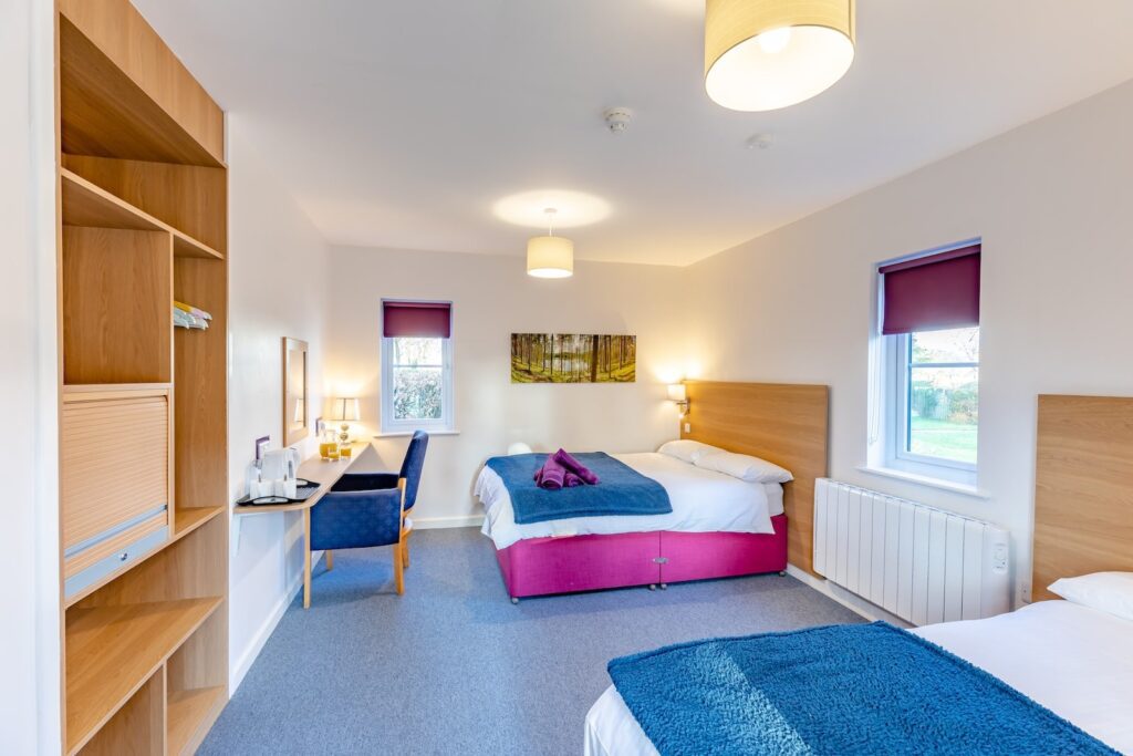 Bedroom with two beds in a Lyneal Wharf cottage