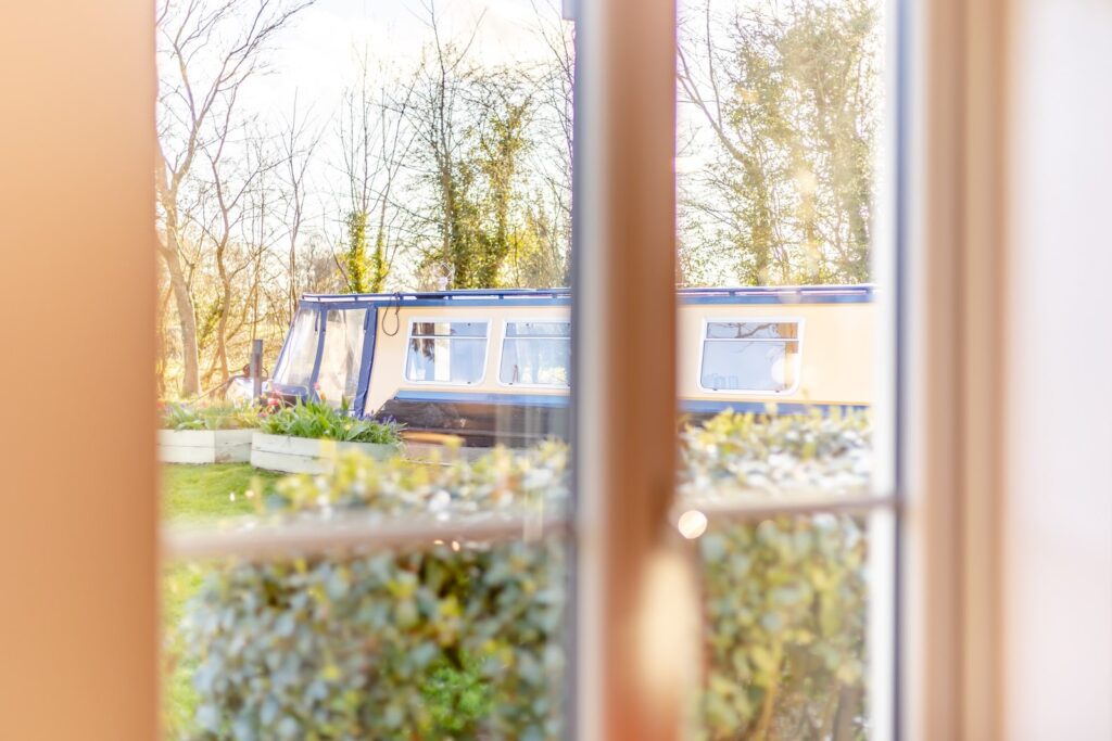 View of a canal boat from a Lyneal Wharf cottage window