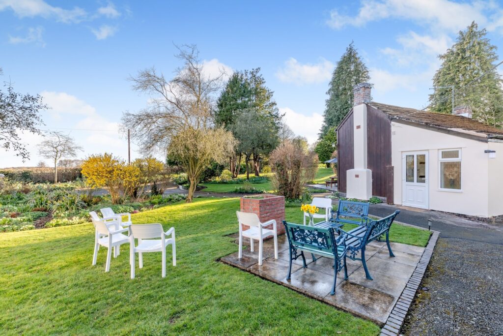 Garden with outdoor seating at Lyneal Wharf cottages