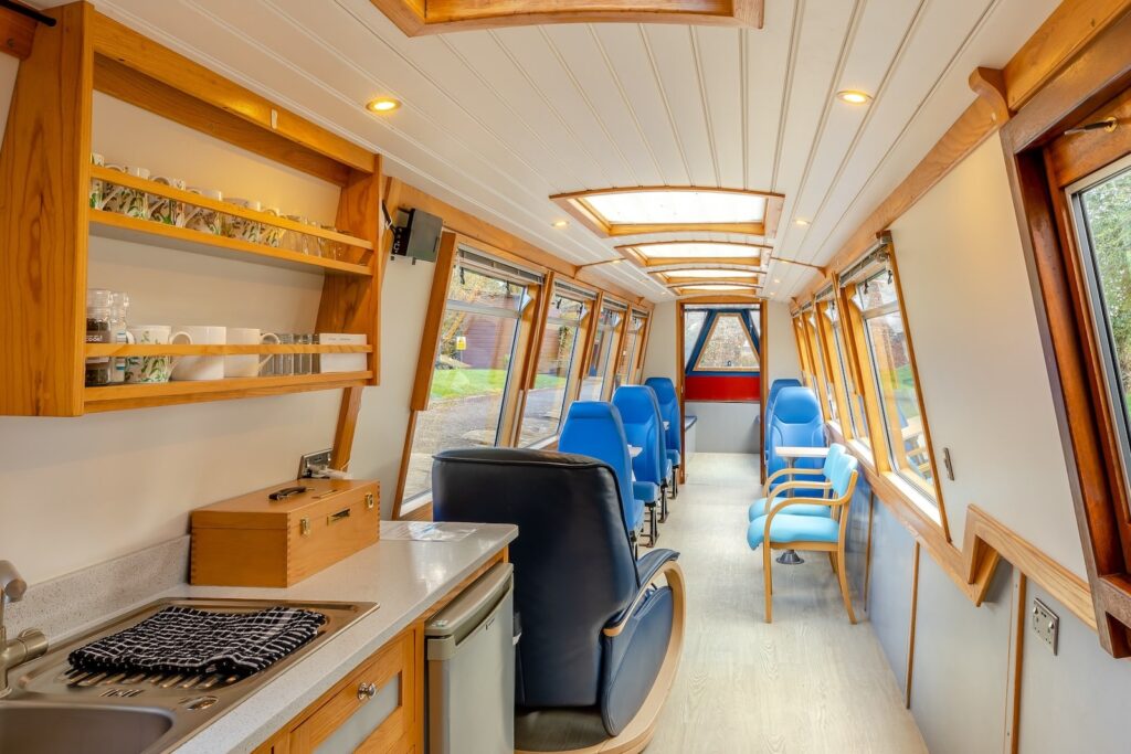 Spacious seating area and kitchen inside the Shropshire Lady canal boat